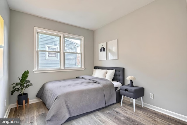 bedroom with hardwood / wood-style flooring