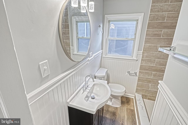 bathroom featuring hardwood / wood-style flooring, toilet, and sink