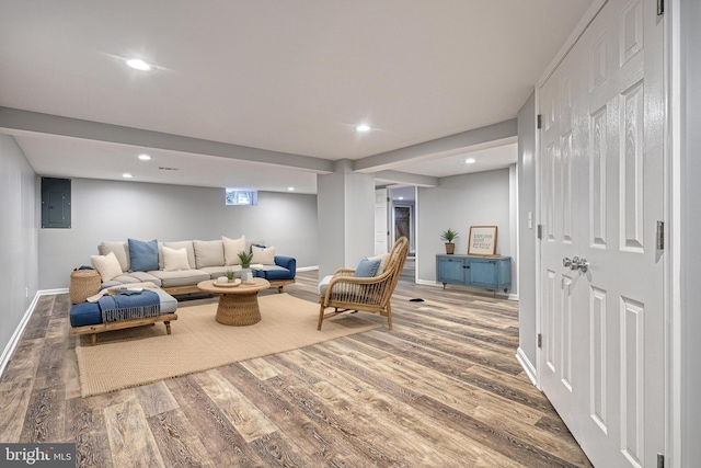 living room featuring electric panel and hardwood / wood-style floors