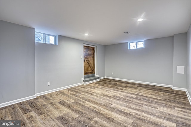 basement with hardwood / wood-style flooring