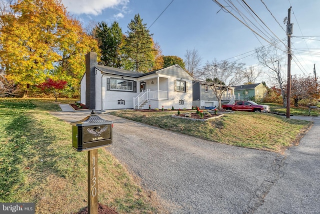 bungalow-style house featuring a front yard