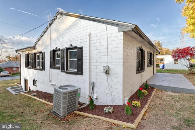 view of home's exterior with central air condition unit and a patio