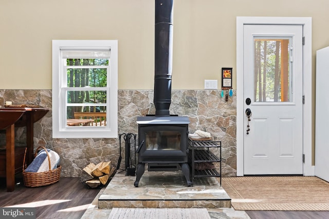 interior details featuring wood-type flooring and a wood stove