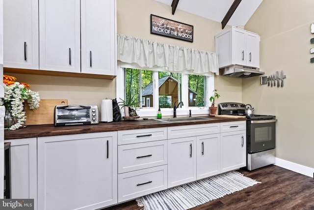 kitchen featuring white cabinets, vaulted ceiling with beams, butcher block counters, and electric stove