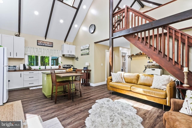 living room featuring beam ceiling, sink, dark wood-type flooring, and high vaulted ceiling