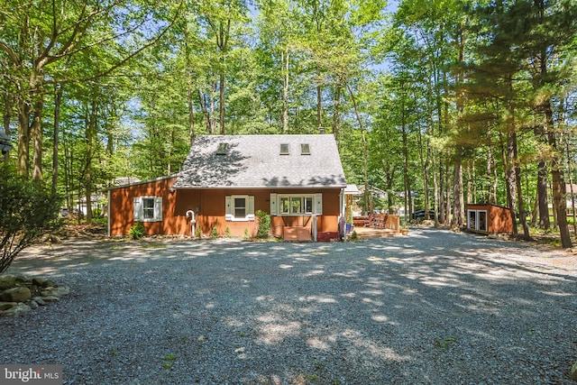 cape cod-style house featuring a shed