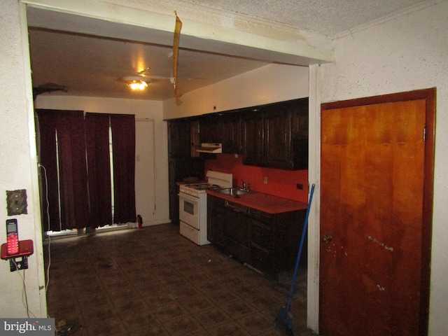 kitchen with a textured ceiling and white range with gas cooktop