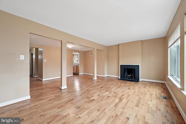 unfurnished living room with light wood-type flooring