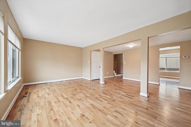 empty room featuring light hardwood / wood-style floors and a wealth of natural light