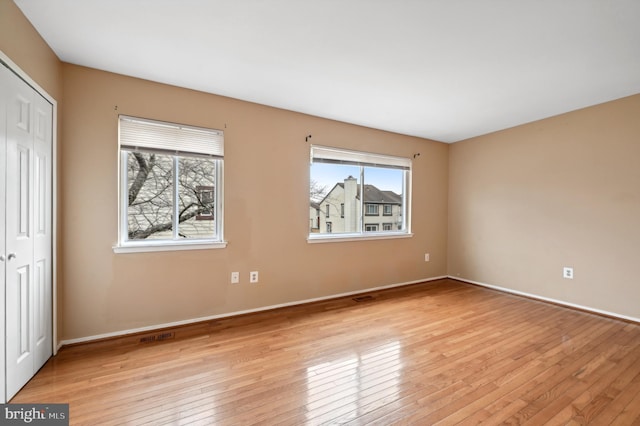 spare room featuring light wood-type flooring