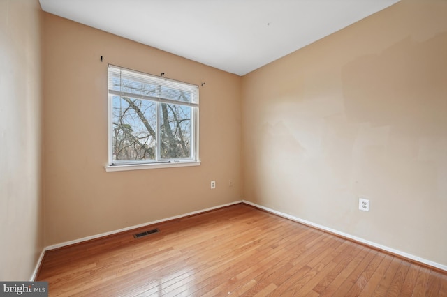 spare room with light hardwood / wood-style flooring