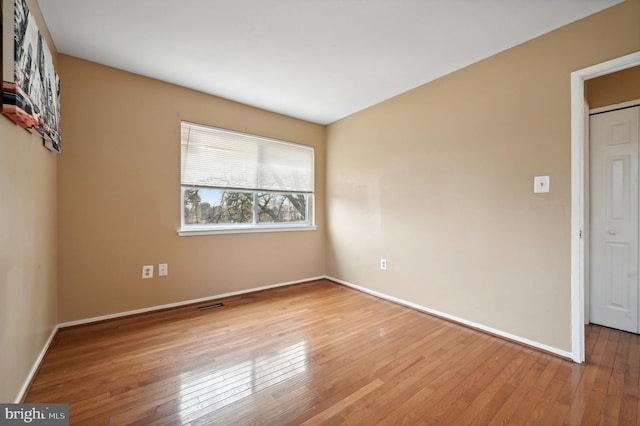 unfurnished room with wood-type flooring