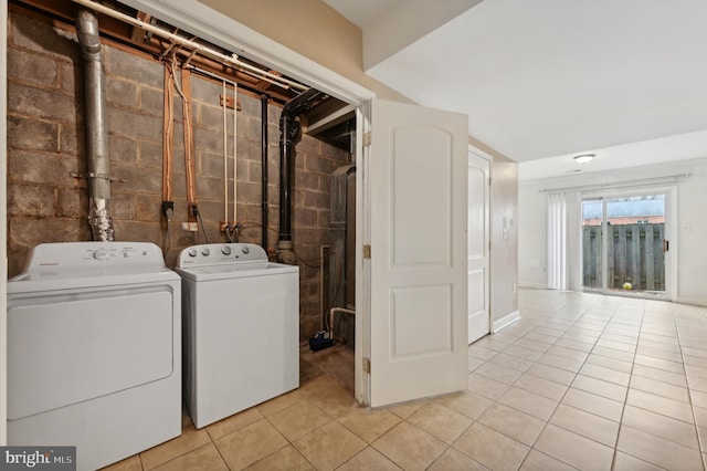 laundry area featuring washer and dryer and light tile patterned floors