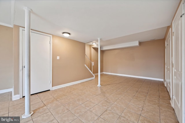 basement with light tile patterned flooring