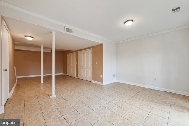 basement with crown molding and light tile patterned flooring