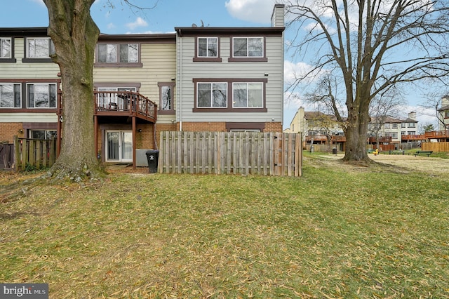 rear view of property with a yard