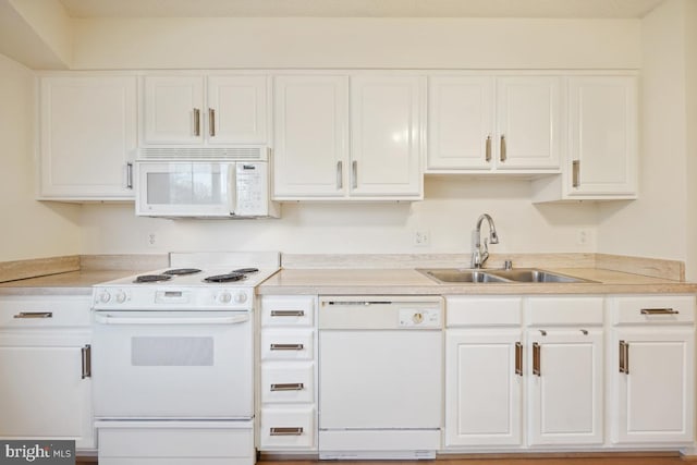 kitchen featuring white appliances, white cabinetry, and sink