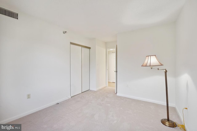 empty room featuring light colored carpet