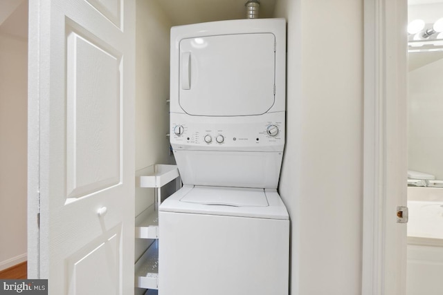 laundry area with stacked washing maching and dryer