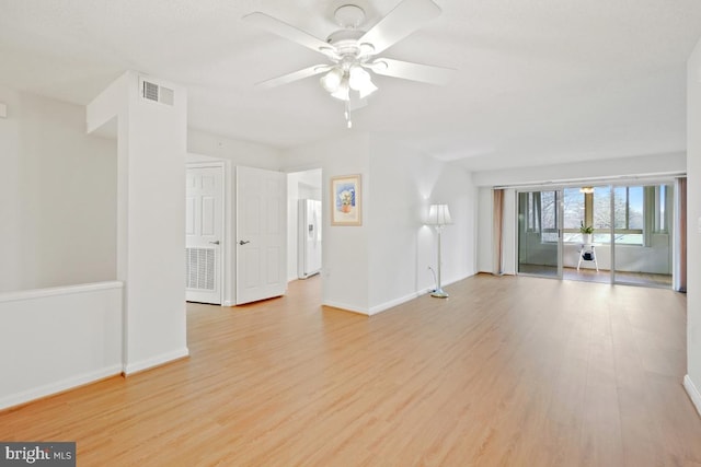 spare room with light wood-type flooring and ceiling fan