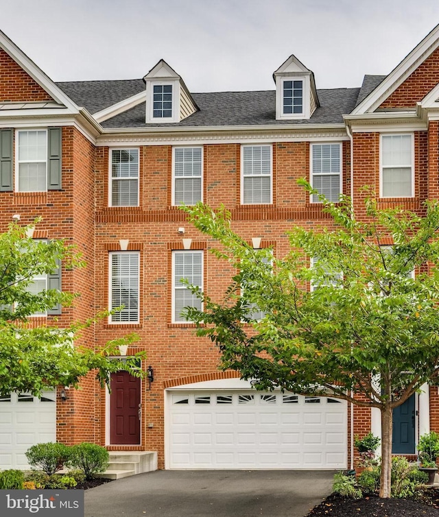 townhome / multi-family property featuring a garage