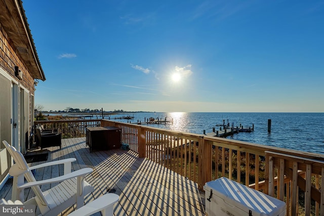 wooden terrace with a water view and a boat dock