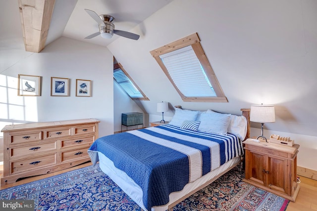 bedroom with ceiling fan, vaulted ceiling, and light wood-type flooring