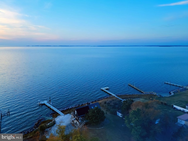 aerial view at dusk with a water view