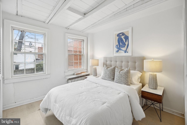 bedroom with wood ceiling, radiator, light hardwood / wood-style floors, and vaulted ceiling with beams