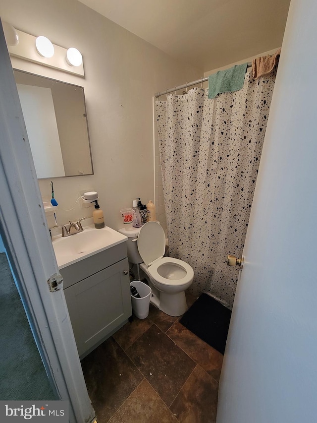 bathroom featuring a shower with curtain, vanity, and toilet