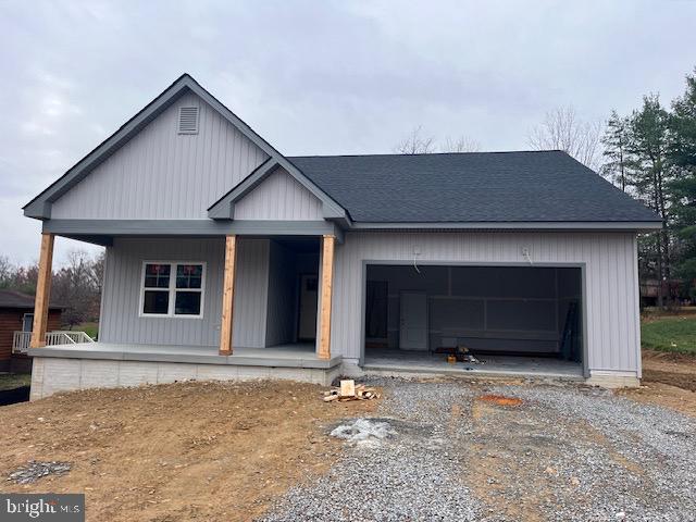 view of front of property featuring a garage and covered porch