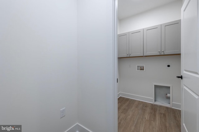 laundry room featuring cabinets, electric dryer hookup, washer hookup, and light wood-type flooring