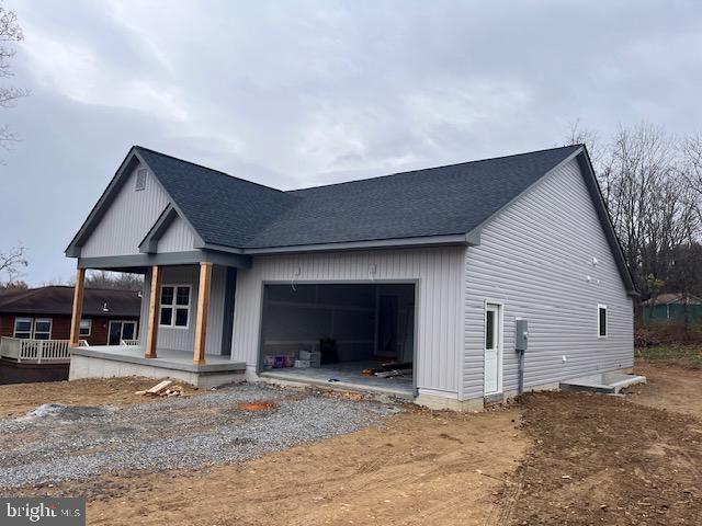 view of front facade with a porch and a garage