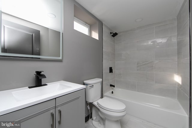 full bathroom with vanity, tiled shower / bath combo, and toilet