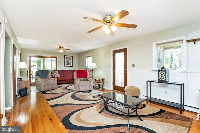 living room featuring hardwood / wood-style flooring, ceiling fan, and a healthy amount of sunlight