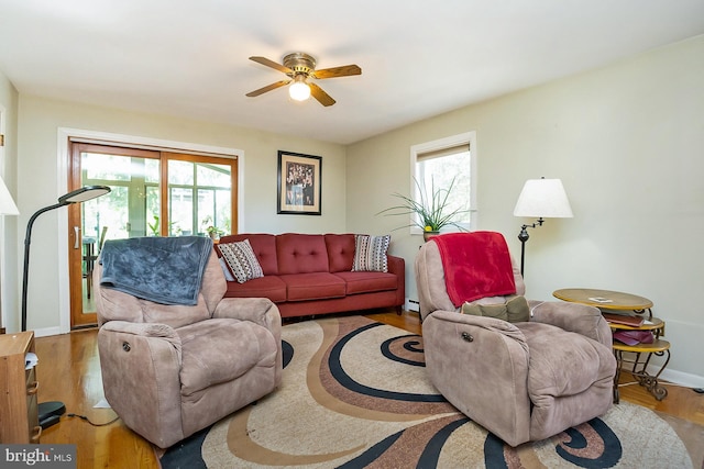 living room with hardwood / wood-style flooring, ceiling fan, a wealth of natural light, and a baseboard radiator