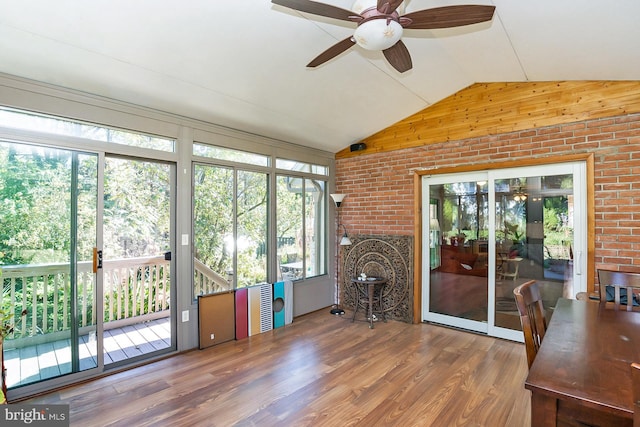 unfurnished sunroom with plenty of natural light, ceiling fan, and lofted ceiling