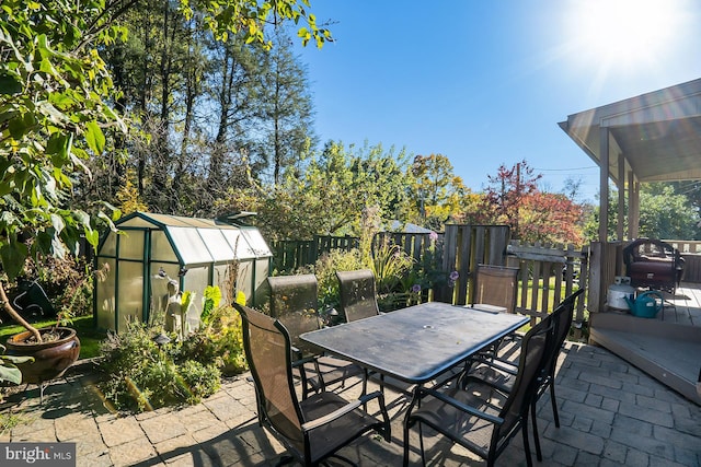 view of patio featuring a shed