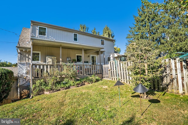 rear view of house with a yard