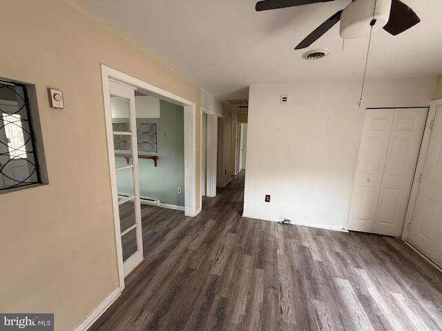 empty room with dark hardwood / wood-style floors and ceiling fan