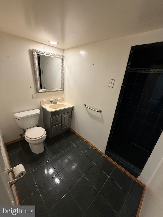 bathroom featuring tile patterned floors, vanity, and toilet