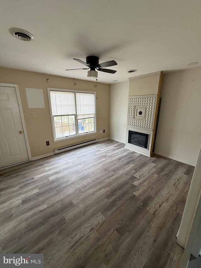 unfurnished living room with baseboard heating, ceiling fan, and wood-type flooring