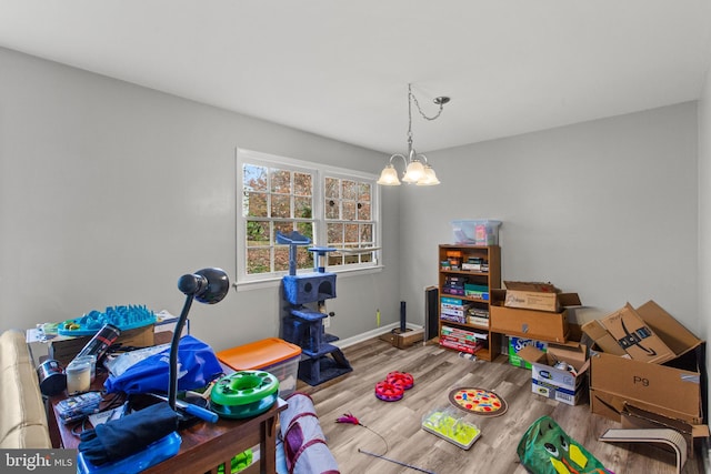 rec room featuring a chandelier and hardwood / wood-style flooring