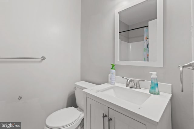 bathroom with vanity, toilet, and walk in shower