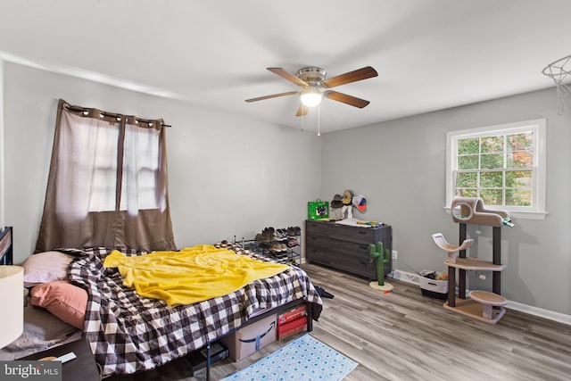 bedroom with ceiling fan and light hardwood / wood-style flooring