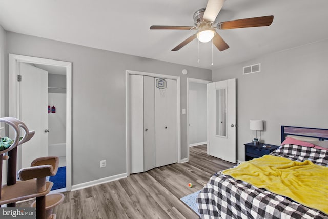 bedroom with a closet, light hardwood / wood-style flooring, and ceiling fan