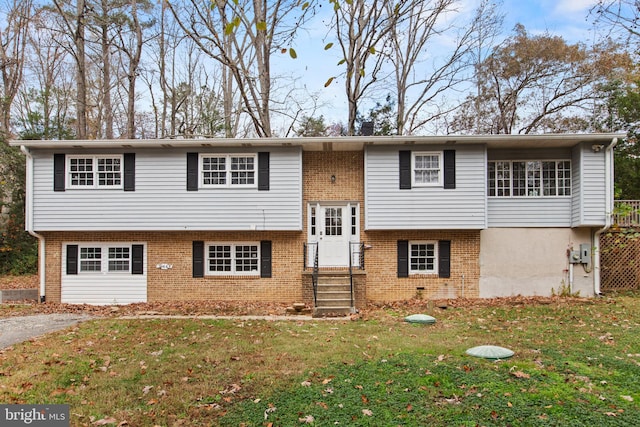 split foyer home with a front lawn