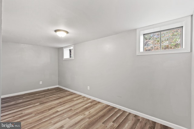 basement featuring a healthy amount of sunlight and hardwood / wood-style flooring