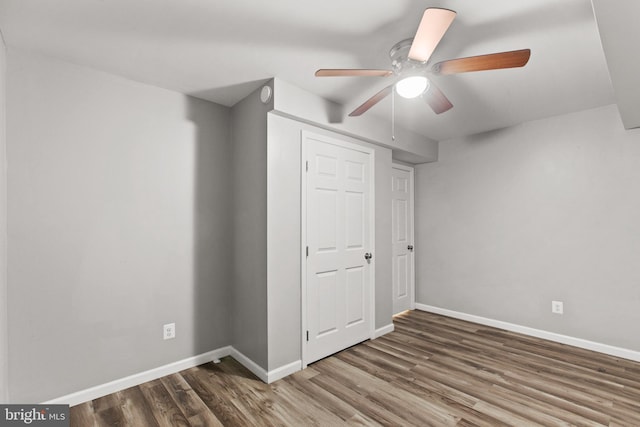 unfurnished bedroom with ceiling fan and hardwood / wood-style flooring