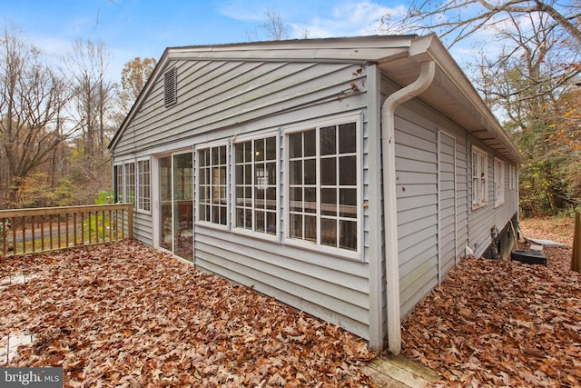 view of property exterior with a sunroom